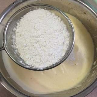 Easy Rice Cooker Sponge Cake Recipe step 4: Sift the cake flour into the batter in three additions. Gently fold after each a