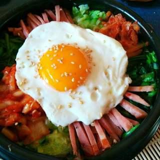 Korean Stone Pot Bibimbap step 8: Place the fried egg on top of the arranged ingredients. Sprinkle with sesame see
