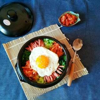 Korean Stone Pot Bibimbap step 9: Add gochujang to taste and mix everything together while hot before serving.