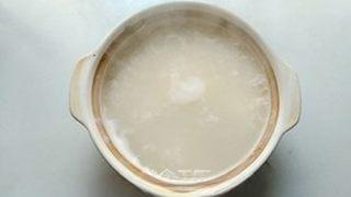 Century Egg and Pork Congee step 3: Return the pot to medium-low heat and simmer until the rice breaks down and the