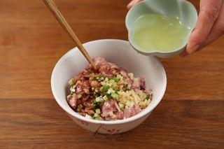 Steamed Glutinous Rice Meatballs step 3: Combine the ground pork, salt, dark soy sauce, egg white, scallions, and ginger