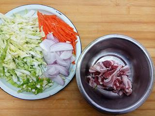 Stir-Fried Rice Noodles with Pork and Vegetables step 5: Slice the cabbage, carrot, and onion into thin strips. Thinly slice the pork bel