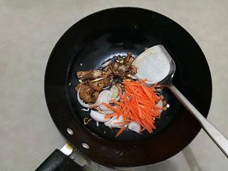 Stir-Fried Rice Noodles with Pork and Vegetables step 8: Add the onion and carrot strips and cook until slightly softened.