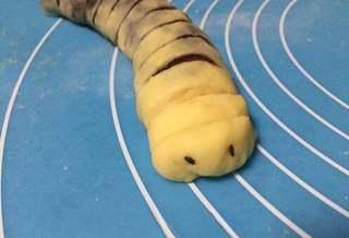 Milk Bread Caterpillar Rolls step 14: Press black sesame seeds into the dough to create eyes.