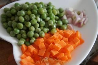 Stir-Fried Sweet Corn with Pine Nuts step 1: Blanch the green peas until tender. Dice the carrot and finely chop the scallion