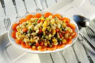 Stir-Fried Sweet Corn with Pine Nuts step 7: Transfer to a serving plate, garnish with carrot slices if desired, and serve im