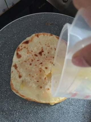 Stuffed Pancake with Egg and Sausage step 9: Make a small opening in the center of the pancake, pour in the beaten eggs, and 