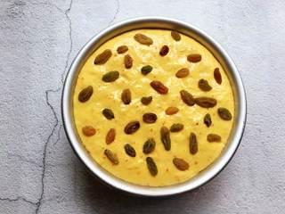 Sweet Pumpkin Steamed Cake Recipe step 7: Top with raisins or other desired toppings. Place the pan into a steamer over bo