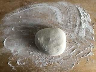 Sesame Twisted Steamed Rolls step 2: Transfer the risen dough to a work surface, knead briefly to remove excess air, 