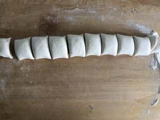 Sesame Twisted Steamed Rolls step 6: Cut the dough log into evenly sized pieces.