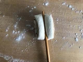 Sesame Twisted Steamed Rolls step 7: Press the center of each piece lengthwise using a chopstick.