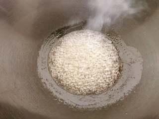 Sweet Red Bean Glutinous Rice Dumplings step 1: Combine water and sugar in a saucepan. Simmer gently over low heat until the sug
