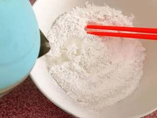 Sweet Red Bean Glutinous Rice Dumplings step 2: Gradually add hot water to the glutinous rice flour, stirring continuously to ev