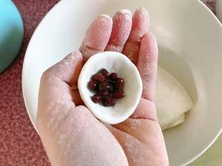 Sweet Red Bean Glutinous Rice Dumplings step 8: Place a spoonful of sweetened red beans in the center of each dough cup.