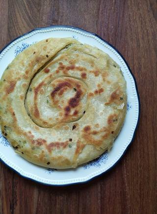 Scallion Pancakes step 10: Heat a lightly oiled skillet or griddle over medium heat. Cook the pancake on bo