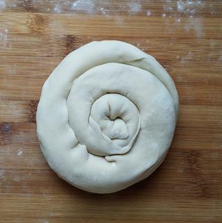 Scallion Pancakes step 8: Coil the log into a spiral shape and tuck the end underneath.