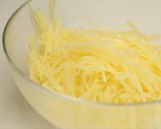 Hot and Sour Shredded Potatoes step 4: Bring a pot of water to a boil. Blanch the potato strips for about 15 seconds, t