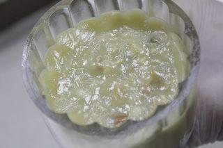 Five-Nut Mooncakes step 11: Dust the mooncake mold lightly with flour and place the filled dough inside.
