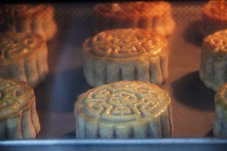 Five-Nut Mooncakes step 15: Remove from the oven, cool slightly, brush with egg wash, then bake again at 150