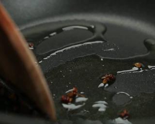 Hot and Sour Stir-Fried Cabbage step 5: Heat cooking oil in a wok over medium heat. Add the Sichuan peppercorns and cook