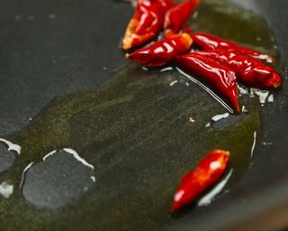 Hot and Sour Stir-Fried Cabbage step 6: Add the dried chilies and stir-fry briefly until aromatic.