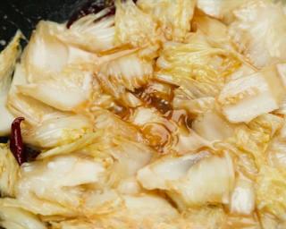 Hot and Sour Stir-Fried Cabbage step 8: Pour in the prepared sauce and cook for 1 minute. Stir in a cornstarch slurry an