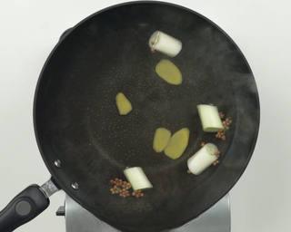 Braised Pork Ribs step 2: Place Sichuan peppercorns, ginger slices, and green onion in a pot with water. H