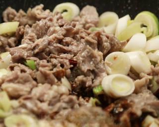 Scallion Lamb Stir-Fry step 10: Pour in the prepared sauce and toss rapidly until everything is evenly coated.