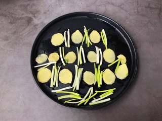 Steamed Fish Head with Chili Sauce step 3: Arrange ginger slices and scallion whites on the bottom of a heatproof serving p