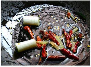 Fermented Tofu Braised Chicken Wings step 3: Heat oil in a wok or skillet. Add the dried chilies, ginger, scallions, and star