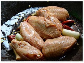 Fermented Tofu Braised Chicken Wings step 4: Add the marinated chicken wings and stir-fry for about 30 seconds to coat them w