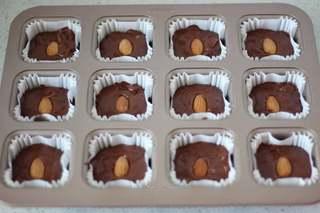 Dark Chocolate Walnut Brownies step 15: Decorate the tops with whole hazelnuts and extra walnut pieces.