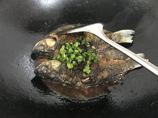 Braised Sea Bass Recipe step 8: Simmer until the fish is fully cooked and the sauce has slightly reduced. Garnis