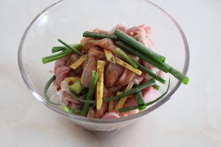 Sweet and Sour Pork Strips step 3: Place the pork strips in a bowl with the green onions and ginger. Add a little s