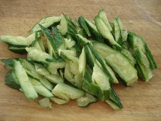 Smashed Cucumber Salad step 2: Cut the smashed cucumbers into bite-sized pieces and transfer them to a mixing b