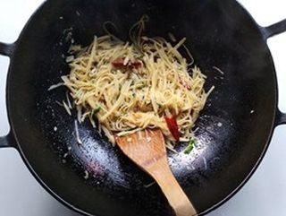 Hot and Sour Shredded Potatoes step 10: Season with sugar, vinegar, and a pinch of salt. Stir-fry over high heat until e