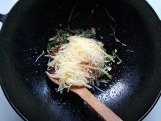 Hot and Sour Shredded Potatoes step 9: Add the blanched potato shreds to the wok.