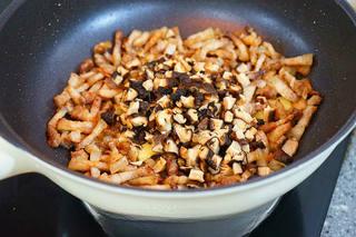 Braised Pork Belly with Mushrooms and Eggs step 12: Add the chopped mushrooms and stir-fry for several minutes.