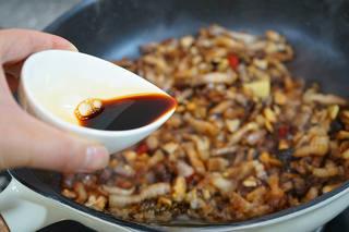 Braised Pork Belly with Mushrooms and Eggs step 14: Add light soy sauce and a small amount of dark soy sauce. Stir until the pork is