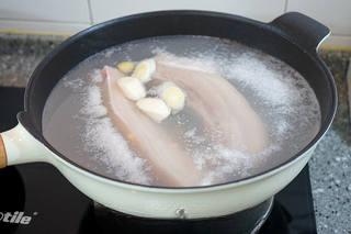 Braised Pork Belly with Mushrooms and Eggs step 2: Place the pork belly in a pot with water, scallions, and ginger. Bring to a boil