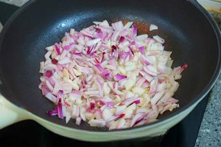 Braised Pork Belly with Mushrooms and Eggs step 7: Heat oil in a wok and slowly fry the diced onions over medium-low heat until gol