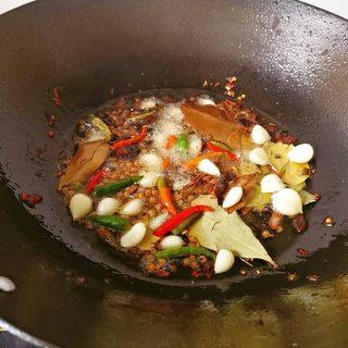 Spicy Mala Stir-Fry with Pork, Shrimp and Mixed Vegetables step 11: Add the hot pot base and cook until the red oil is released.