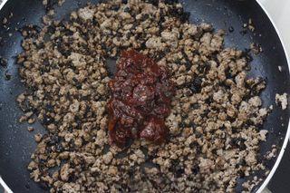 Spicy Beef Chili Crisp step 4: Add the mashed fermented black beans and cook over medium heat until fragrant.