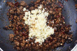 Spicy Beef Chili Crisp step 5: Stir in the chili bean sauce and continue cooking until the oil turns red and ar