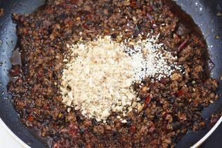 Spicy Beef Chili Crisp step 8: Sprinkle in the chili powder and stir well to evenly distribute the spice.