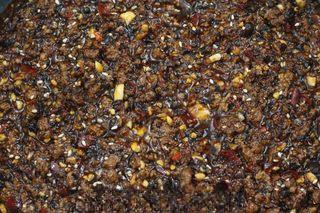 Spicy Beef Chili Crisp step 9: Add the crushed peanuts and white sesame seeds. Reduce the heat and simmer gentl
