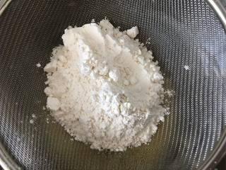 Japanese Yogurt Cheesecake step 5: Sift the cake flour into the yogurt mixture.
