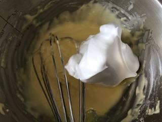 Japanese Yogurt Cheesecake step 8: Fold one-third of the whipped egg whites into the yolk batter to lighten the mix
