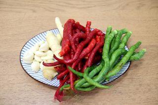 Sizzling Chili Garlic Sauce step 1: Wash the red and green chilies thoroughly and allow them to dry completely. Peel