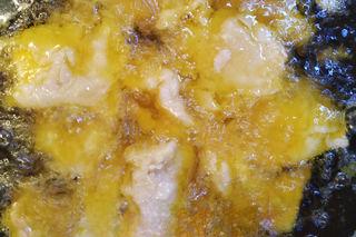 Sweet and Sour Pork step 6: Heat oil to medium temperature and fry the coated pork until lightly set. Remove